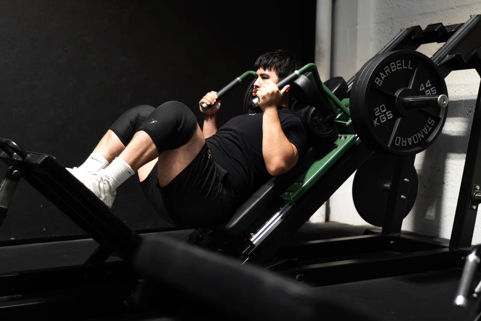 A lifter training on the hack squat machine at ZeroW Wales