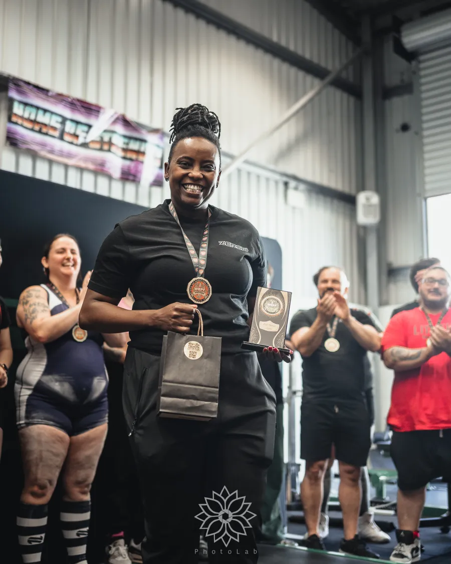 A lifter receiving her medal at the presentation